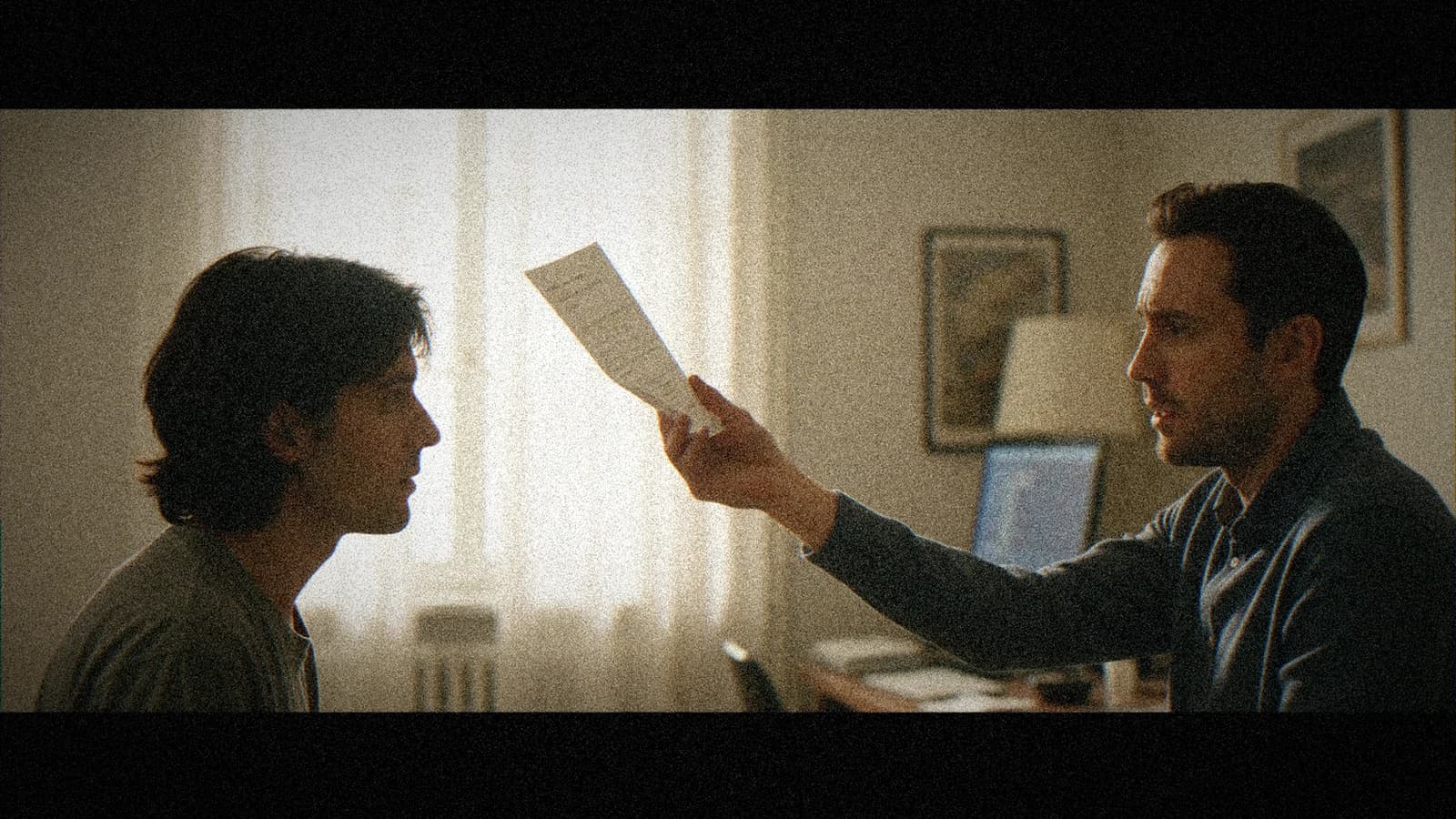 Two actors rehearsing a scene in an apartment, an annotated screenplay and a computer with AI off-frame