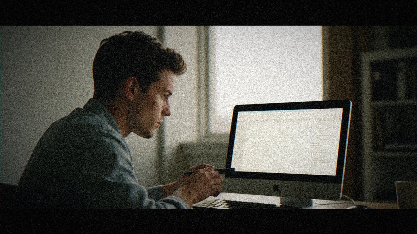 Annotated screenplay with subtext, computer open on an AI assistant and a cinematic desk light