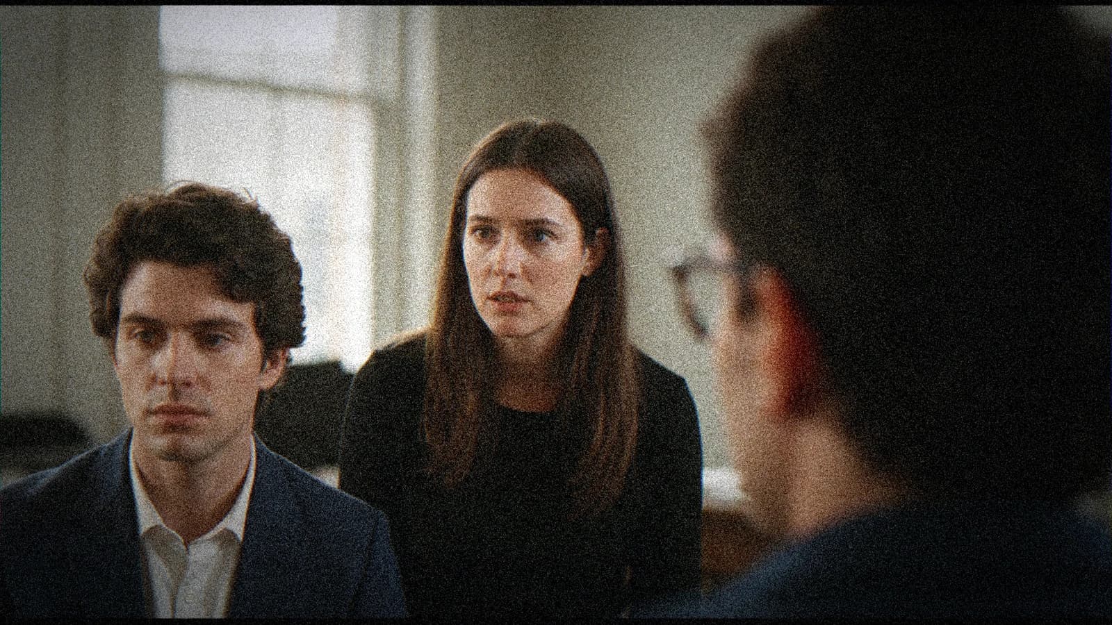 Creative team examining a printed visual intention note in a pre-production setting