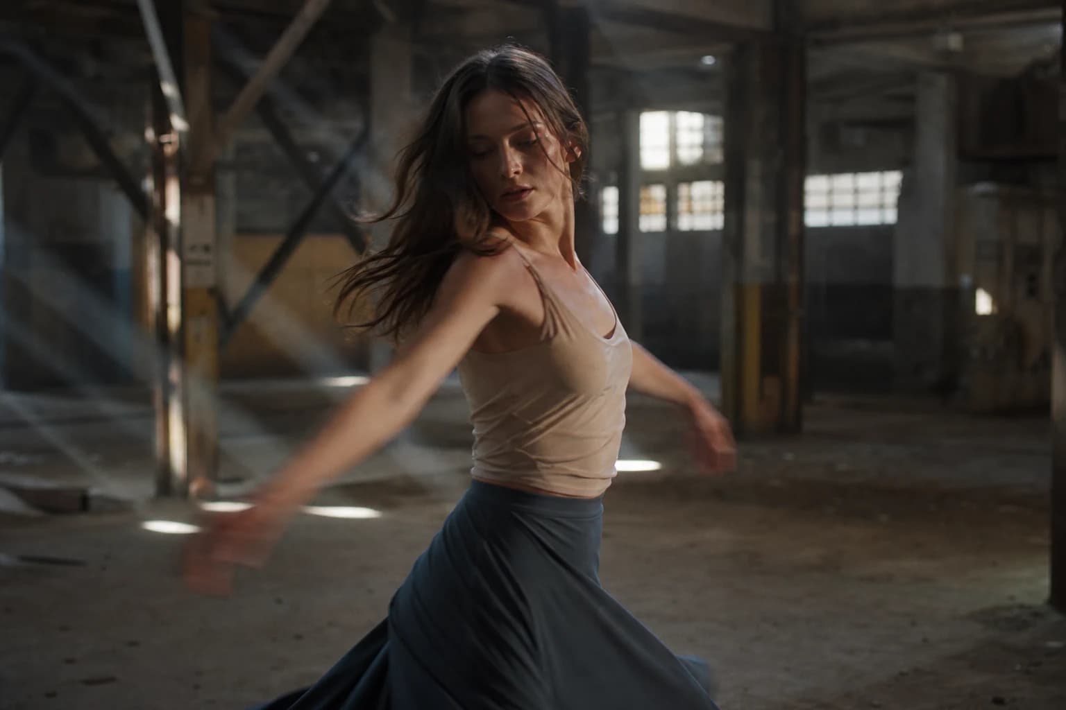 Dancer in slow rotation in a warehouse, volumetric light, Kling 3 movement reference